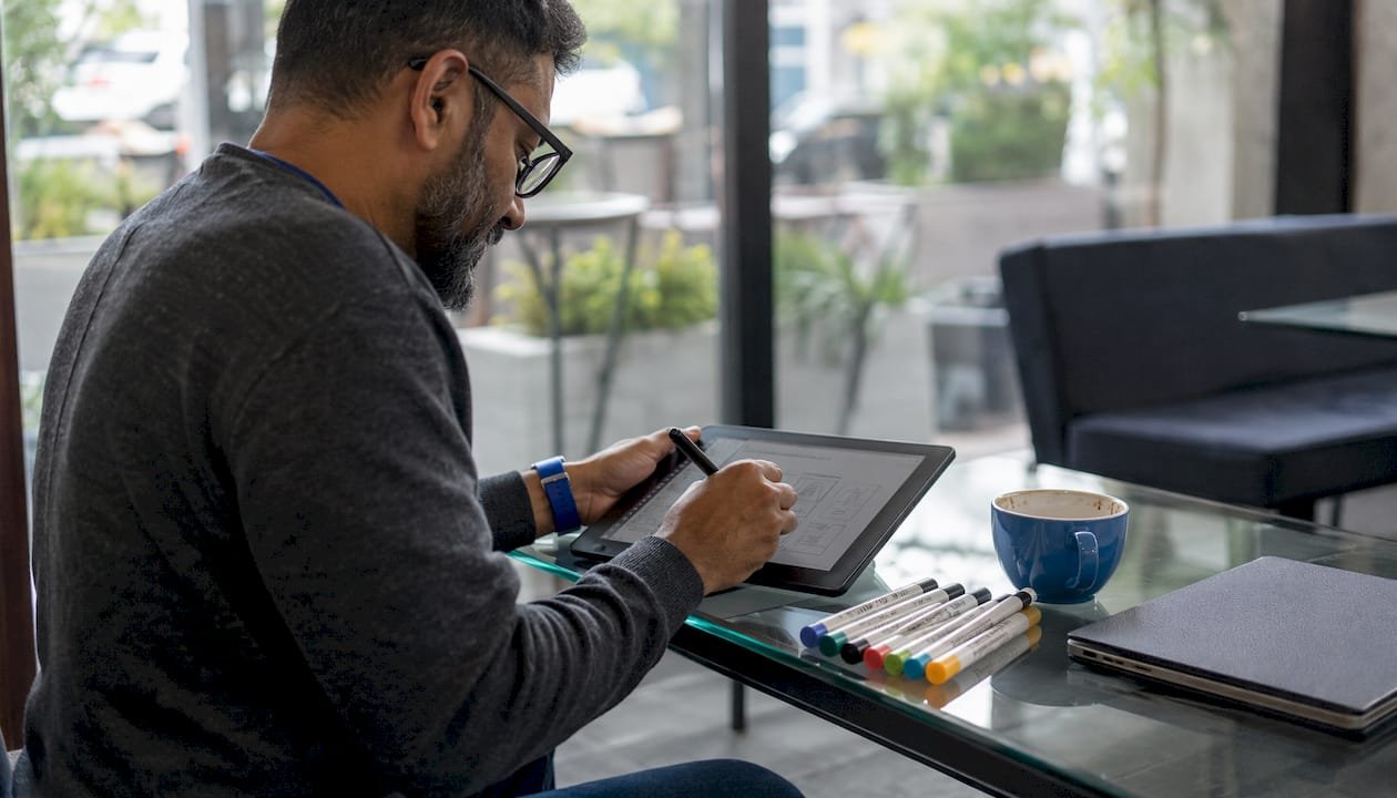 Man designing Pinterest pin wireframes in studio