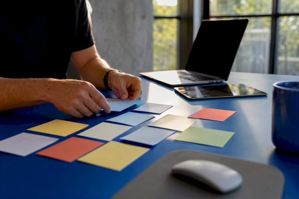 Hands arranging research cards on modern desk