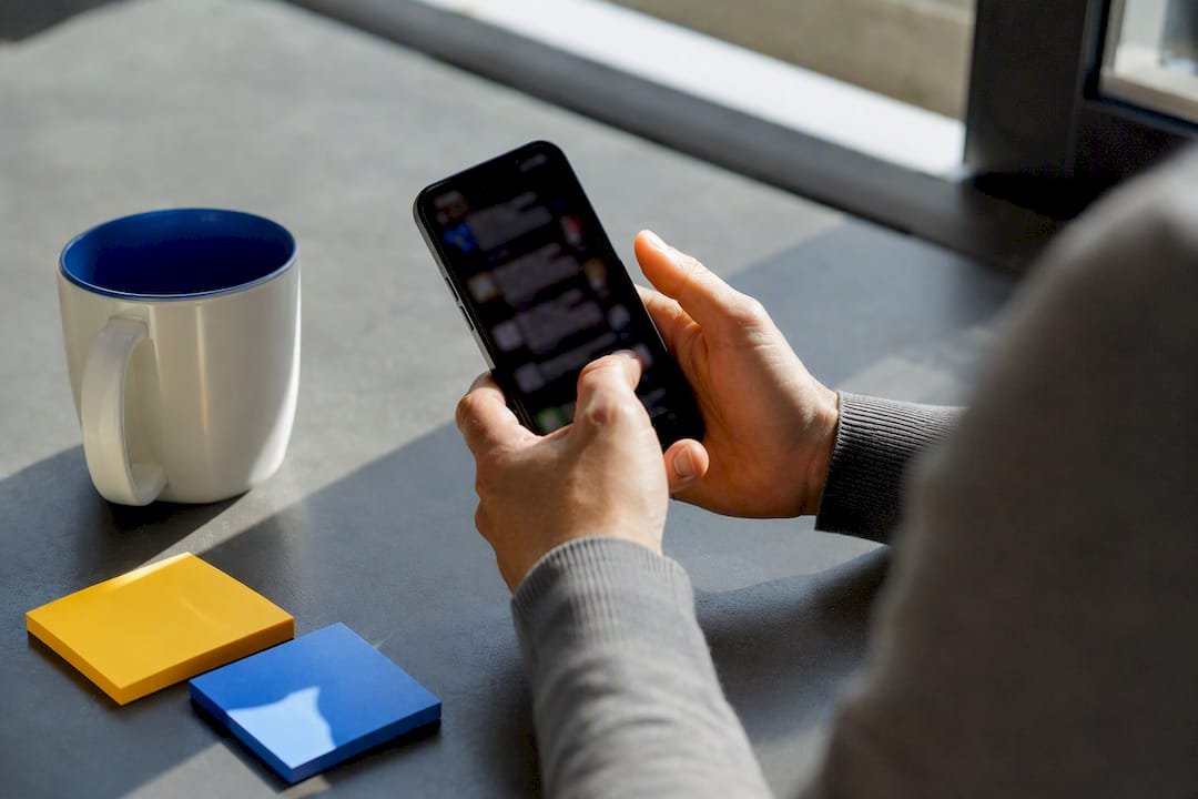 Hands scrolling social media for trend research