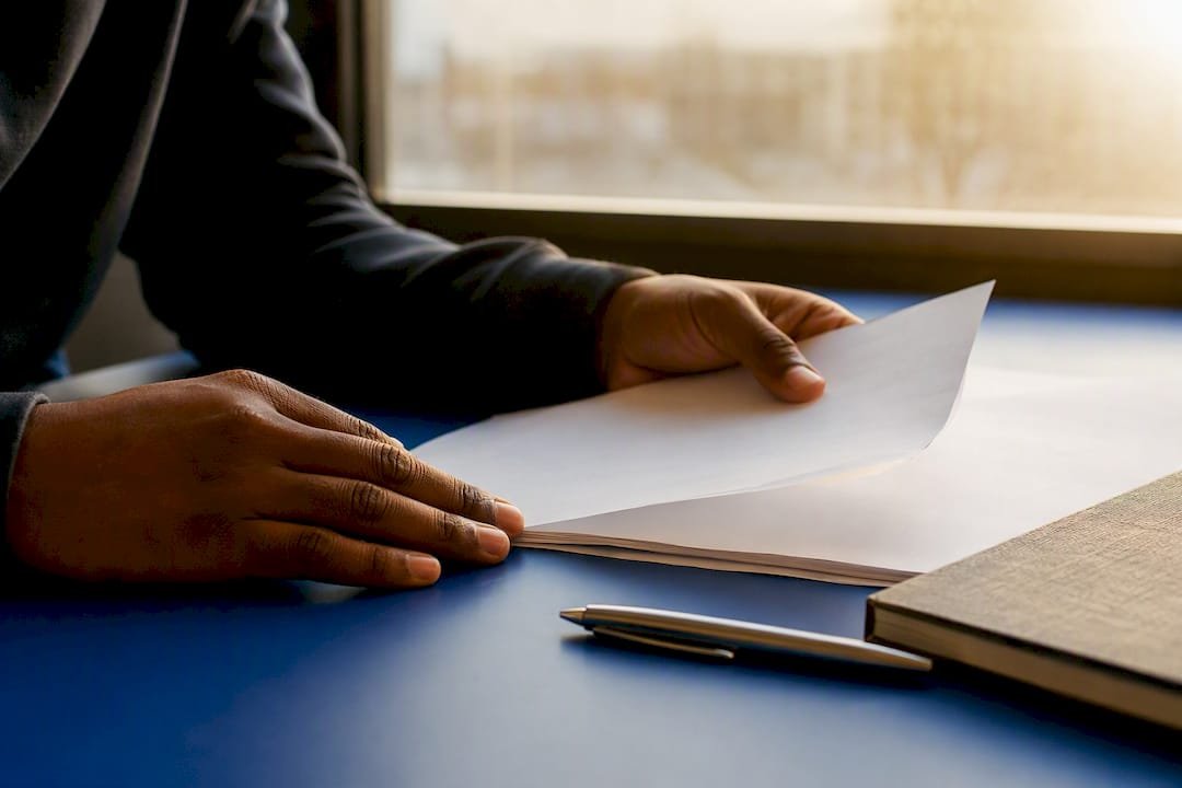 Hands handling site audit checklist on desk