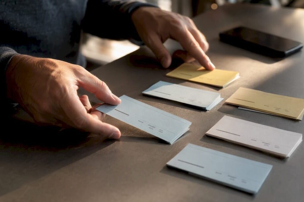 Hands arranging keyword research cards
